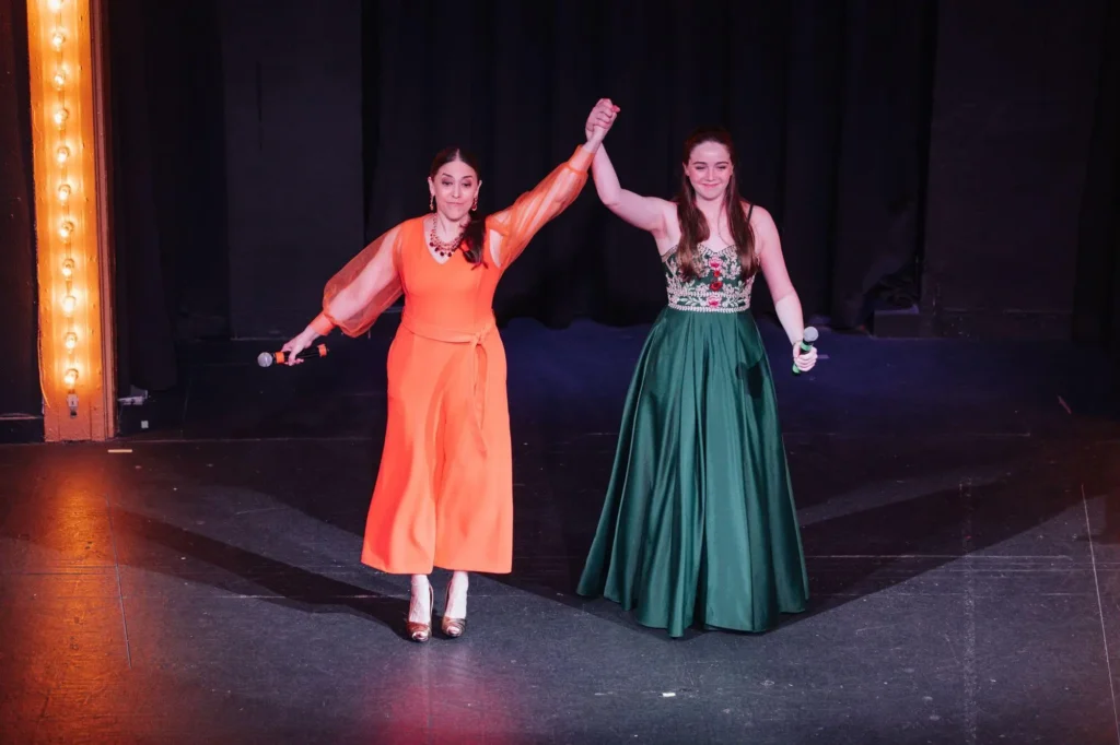 Vocal student performing on stage at a recital